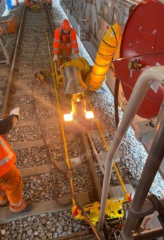 Regen? Sengende Sonne? Kein Problem, die „fahrende Werkstatt“ ist bei Wind und Wetter einsetzbar und schützt vor vorbeifahrenden Zügen. © DB Netz/ Alexander_Ae_Paul Zwei Bahnarbeiter arbeiten konzentriert an der Reparatur der Gleise